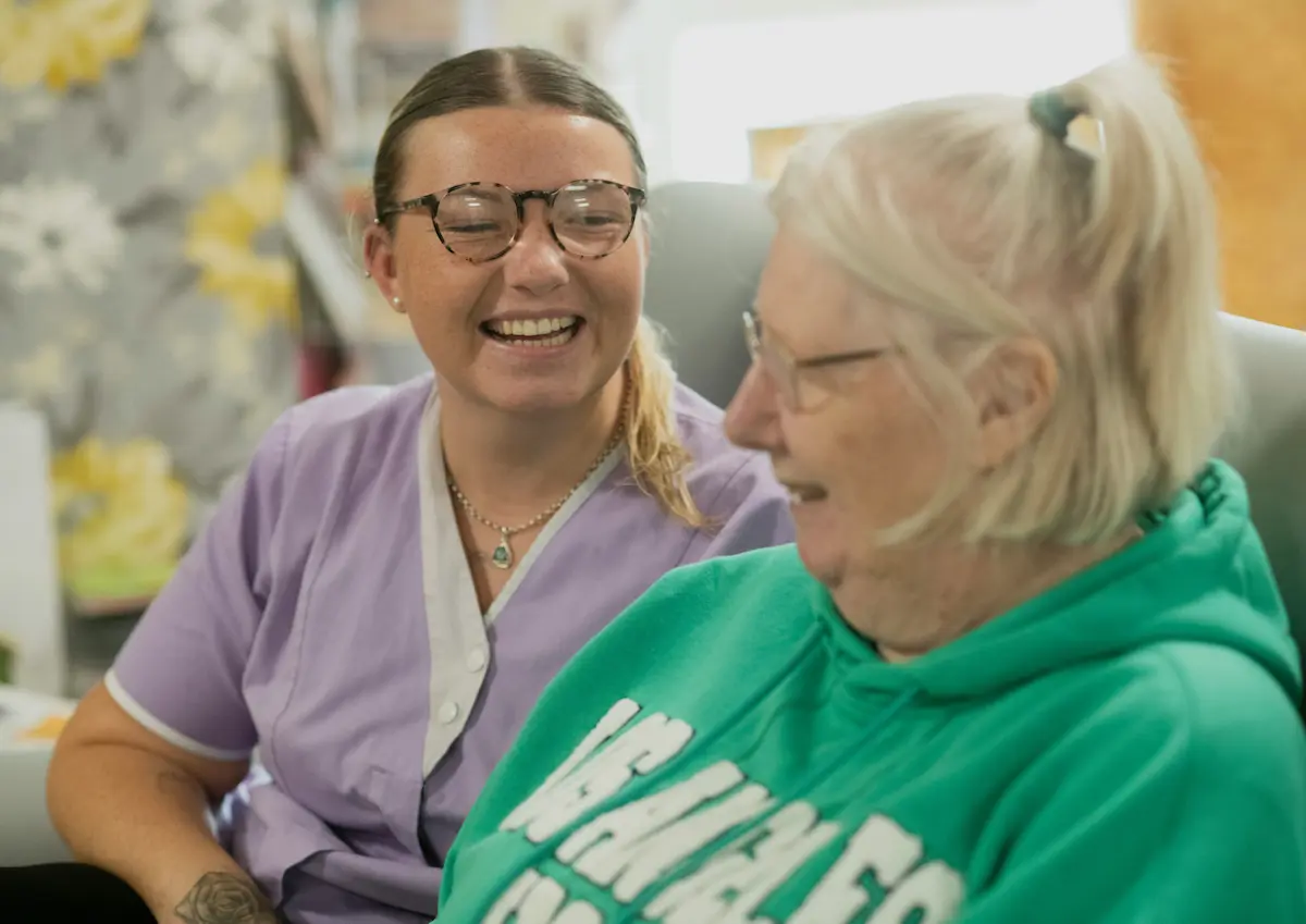 A caregiver sharing a moment with a resident